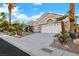 Charming single-story home featuring desert landscaping, mature palm trees, and a two-car garage at 2621 Spalding Dr, Las Vegas, NV 89134