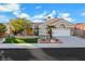 Well-maintained single-story home with desert landscaping, green lawn, and a two-car garage at 2621 Spalding Dr, Las Vegas, NV 89134