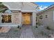 Inviting home entrance with custom double doors, stone accents, and lush desert landscaping at 2621 Spalding Dr, Las Vegas, NV 89134