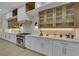Modern kitchen featuring white cabinets, stainless steel appliances, and sleek countertops, illuminated by stylish lighting at 2621 Spalding Dr, Las Vegas, NV 89134