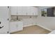 Bright laundry room with white cabinets, sink, and a window offering natural light and backyard view at 2621 Spalding Dr, Las Vegas, NV 89134
