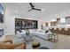 Contemporary living room flows into a modern kitchen with an island and bar seating at 2621 Spalding Dr, Las Vegas, NV 89134