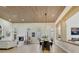 Open living area with a modern fireplace, wood ceiling, and view into the dining room at 2621 Spalding Dr, Las Vegas, NV 89134