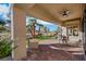 The covered patio features brick pavers and a ceiling fan for added comfort and overlooks desert landscaping at 2621 Spalding Dr, Las Vegas, NV 89134