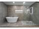 Stunning bathroom featuring a soaking tub, walk-in shower, and illuminated vanity mirrors at 2909 Gilmary Ave, Las Vegas, NV 89102