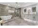 Beautiful bathroom featuring a soaking tub, walk-in shower, and double vanity sinks with illuminated mirrors at 2909 Gilmary Ave, Las Vegas, NV 89102