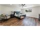 Bright bedroom featuring a dark wood bed frame, ceiling fan, and natural lighting at 2909 Gilmary Ave, Las Vegas, NV 89102