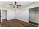 Bright bedroom features dark wood floors, a ceiling fan, and a closet with sliding doors at 2909 Gilmary Ave, Las Vegas, NV 89102