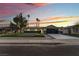 Charming single-story home featuring a putting green and modern garage door at dusk at 2909 Gilmary Ave, Las Vegas, NV 89102