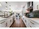 Modern kitchen with stainless steel appliances, white cabinetry, and open layout at 2909 Gilmary Ave, Las Vegas, NV 89102