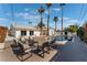 Outdoor pool area with patio seating, mature landscaping, and a slide at 2909 Gilmary Ave, Las Vegas, NV 89102