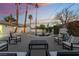 Backyard pool at dusk with elegant seating and tall palm trees at 2909 Gilmary Ave, Las Vegas, NV 89102