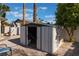 Outdoor storage shed located in a gravel area of the backyard with landscaping and sunny sky at 2909 Gilmary Ave, Las Vegas, NV 89102