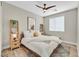 Well-decorated bedroom with a ceiling fan, light-colored bedding, and unique decor elements at 3179 Mura Del Prato Ave, Henderson, NV 89044