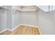 Walk-in closet with white shelving and hardwood floors at 3179 Mura Del Prato Ave, Henderson, NV 89044