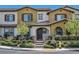 Charming two-story townhome featuring stucco siding, a tiled roof, and a cozy front patio with seating area at 3179 Mura Del Prato Ave, Henderson, NV 89044