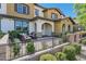 Inviting front patio features sleek outdoor furniture, decorative plants, and a walkway leading to the arched entryway at 3179 Mura Del Prato Ave, Henderson, NV 89044