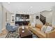 Open-concept living area featuring hardwood floors, comfortable seating, and a modern kitchen with a spacious island at 3179 Mura Del Prato Ave, Henderson, NV 89044