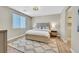 Comfortable bedroom featuring a decorative headboard, rug and natural light at 3179 Mura Del Prato Ave, Henderson, NV 89044