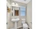 Clean powder room with pedestal sink, tiled floors and natural light at 3179 Mura Del Prato Ave, Henderson, NV 89044
