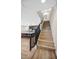 Staircase with wood steps, dark railings, and open layout into a modern kitchen and living area at 3179 Mura Del Prato Ave, Henderson, NV 89044