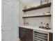 Stylish wet bar with floating shelves, wine fridge and attractive backsplash at 3179 Mura Del Prato Ave, Henderson, NV 89044