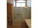 Bright bathroom featuring a shower-tub with glass door and large window allowing natural light at 3208 Regal Swan Pl # 3, North Las Vegas, NV 89084