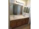Bathroom features double sinks and a framed mirror at 3208 Regal Swan Pl # 3, North Las Vegas, NV 89084