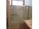 Bathroom tub/shower combination has frameless glass doors and tiled surround at 3208 Regal Swan Pl # 3, North Las Vegas, NV 89084