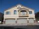 Charming home featuring a three-car garage, upper balcony, and a neutral stucco exterior at 3208 Regal Swan Pl # 3, North Las Vegas, NV 89084