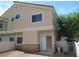 Townhouse with light stucco exterior, front door access, and compact back yard at 3208 Regal Swan Pl # 3, North Las Vegas, NV 89084