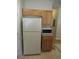 Kitchen with a white refrigerator, microwave and light wood cabinets at 3208 Regal Swan Pl # 3, North Las Vegas, NV 89084