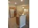 Kitchen overview with stainless appliances, wood cabinets, breakfast bar and tile floors at 3208 Regal Swan Pl # 3, North Las Vegas, NV 89084