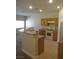 Bright kitchen showcasing appliances, wood cabinets, breakfast bar, and tile floors at 3208 Regal Swan Pl # 3, North Las Vegas, NV 89084