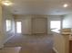 Spacious living room with carpet flooring, neutral paint, and abundant natural light at 3208 Regal Swan Pl # 3, North Las Vegas, NV 89084