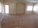 Bright living room featuring neutral carpet, fresh paint, and large windows at 3208 Regal Swan Pl # 3, North Las Vegas, NV 89084