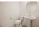 Clean half bath featuring a pedestal sink, white fixtures, and neutral decor at 3270 Trabia Ave, Henderson, NV 89044
