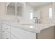 Double vanity bathroom featuring quartz countertops, white cabinets, and chrome faucets at 3270 Trabia Ave, Henderson, NV 89044