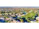 Aerial view of a luxurious community highlighting lush landscaping, a golf course, and a serene pond at 383 Solitude Peak Ln, Henderson, NV 89012