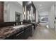 Modern bathroom with marble counters, dual sinks, and a soaking tub overlooking a mountain view at 383 Solitude Peak Ln, Henderson, NV 89012