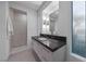 Sleek bathroom with a glass-enclosed shower, modern vanity, and artistic wall sconces at 383 Solitude Peak Ln, Henderson, NV 89012