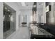 Contemporary bathroom with marble counters, glass shower, and modern lighting at 383 Solitude Peak Ln, Henderson, NV 89012