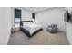 Modern bedroom with sleek platform bed, gray armchair, and wall-mounted TV at 383 Solitude Peak Ln, Henderson, NV 89012