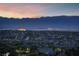City lights glowing in the distance, nestled below a mountain range at twilight at 383 Solitude Peak Ln, Henderson, NV 89012
