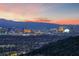 Stunning city skyline panorama at dusk, with the Ferris wheel and hotels lit up at 383 Solitude Peak Ln, Henderson, NV 89012