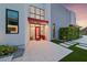 Stunning home entrance with a vibrant red door, high ceilings, and modern landscaping at 383 Solitude Peak Ln, Henderson, NV 89012