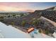 Outdoor patio with sunset views, modern seating, and desert landscaping at 383 Solitude Peak Ln, Henderson, NV 89012