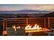 Inviting fire pit area offers stunning city views, creating a perfect space for relaxation and entertaining at 383 Solitude Peak Ln, Henderson, NV 89012