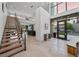Bright foyer with high ceilings, modern staircase, and floor-to-ceiling windows offering natural light at 383 Solitude Peak Ln, Henderson, NV 89012