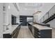 Bright kitchen with marble countertops, stainless steel appliances, custom cabinets, and an adjacent staircase at 383 Solitude Peak Ln, Henderson, NV 89012